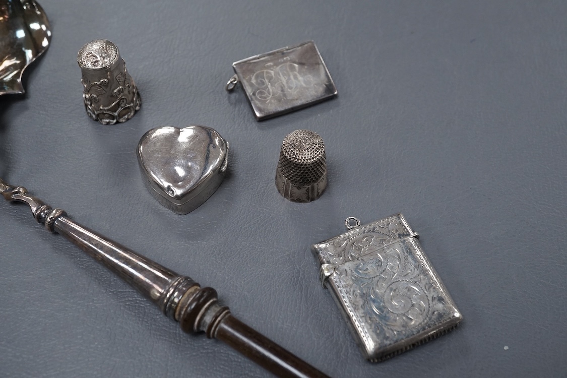 A small group of collectable silver including a George III silver cream jug, London, 1804, height 95mm, three silver vesta cases, two pill boxes, an envelope stamp case, two Georgian toddy ladles, one unmarked, together